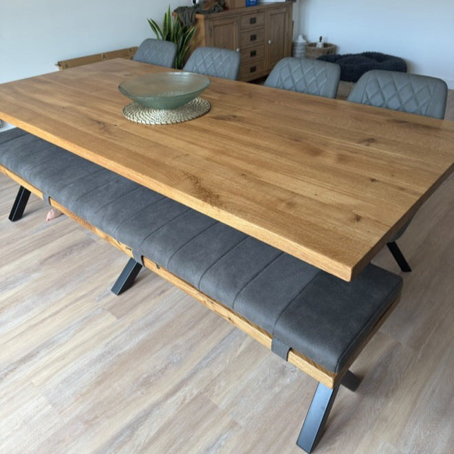 Wooden dining table with gray chairs and bench