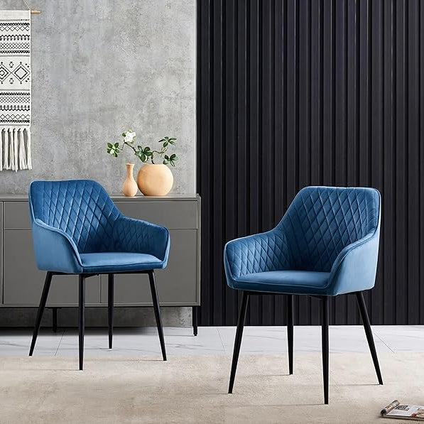 Two blue chairs in a room with a gray wall and black curtain.