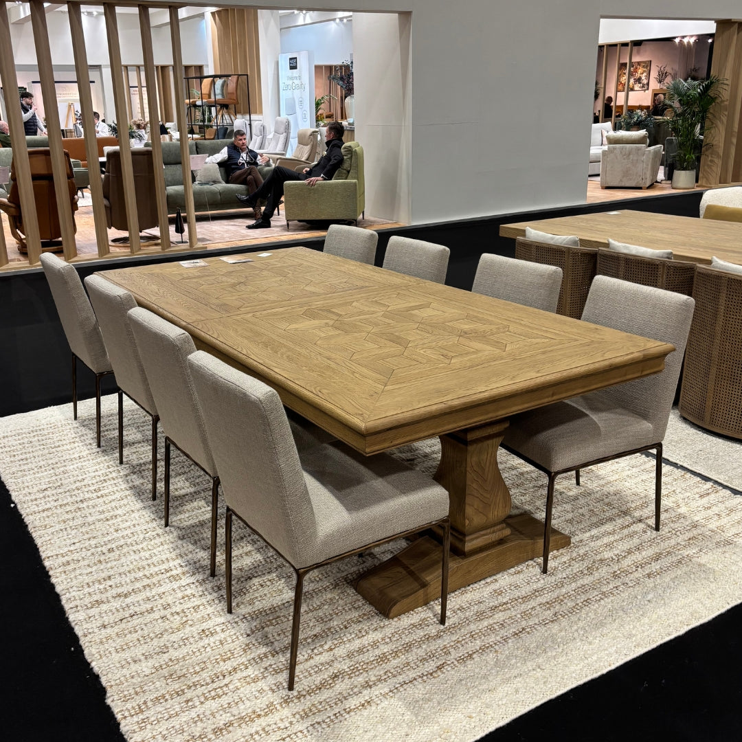 Dining table set with chairs in a showroom setting