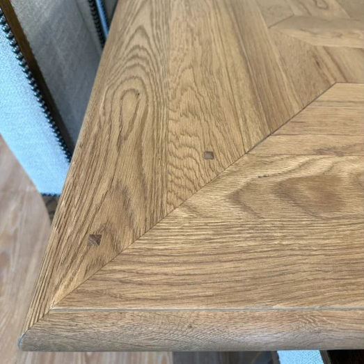 Wooden table with a chevron pattern on a white background