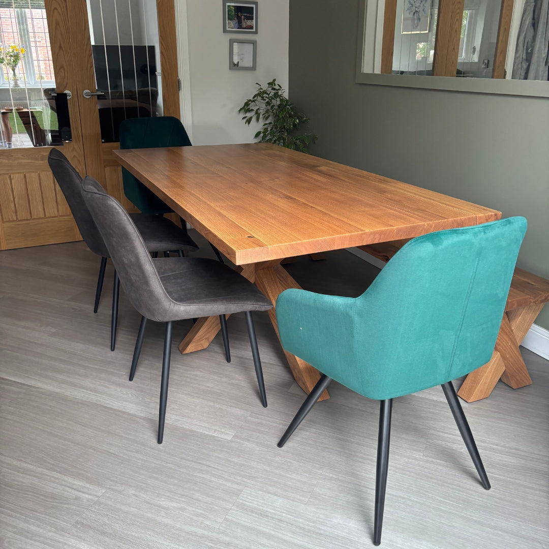 Dining area with wooden table and chairs including a teal chair.