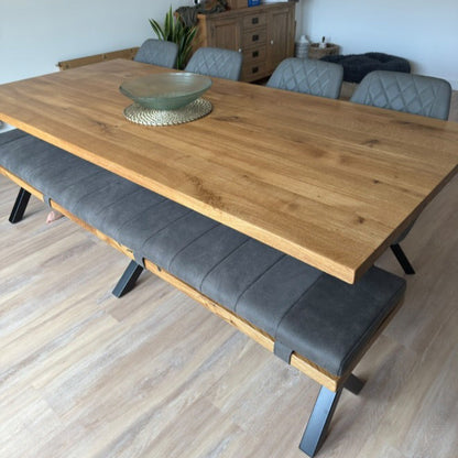 Wooden dining table with gray chairs and bench