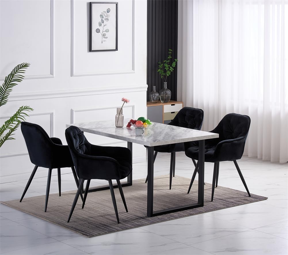 Dining room setup with a marble table and black chairs in a bright room.