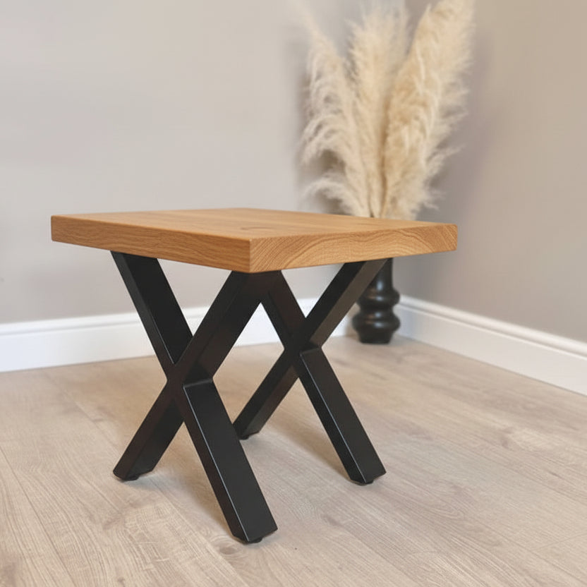 Small Oak wooden table with black metal legs on a light wood floor.