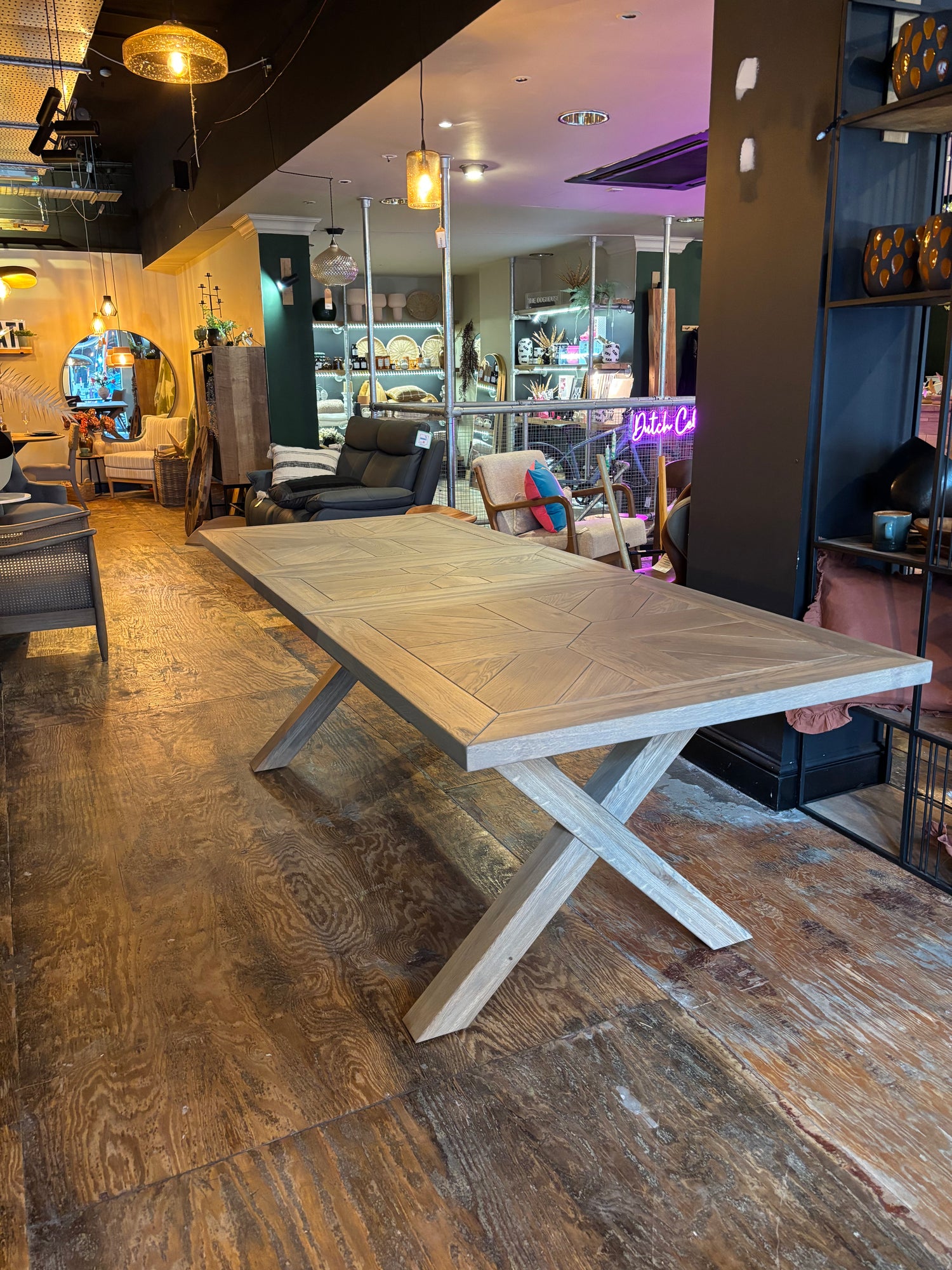 Wooden dining table in a modern interior setting with furniture and decor.