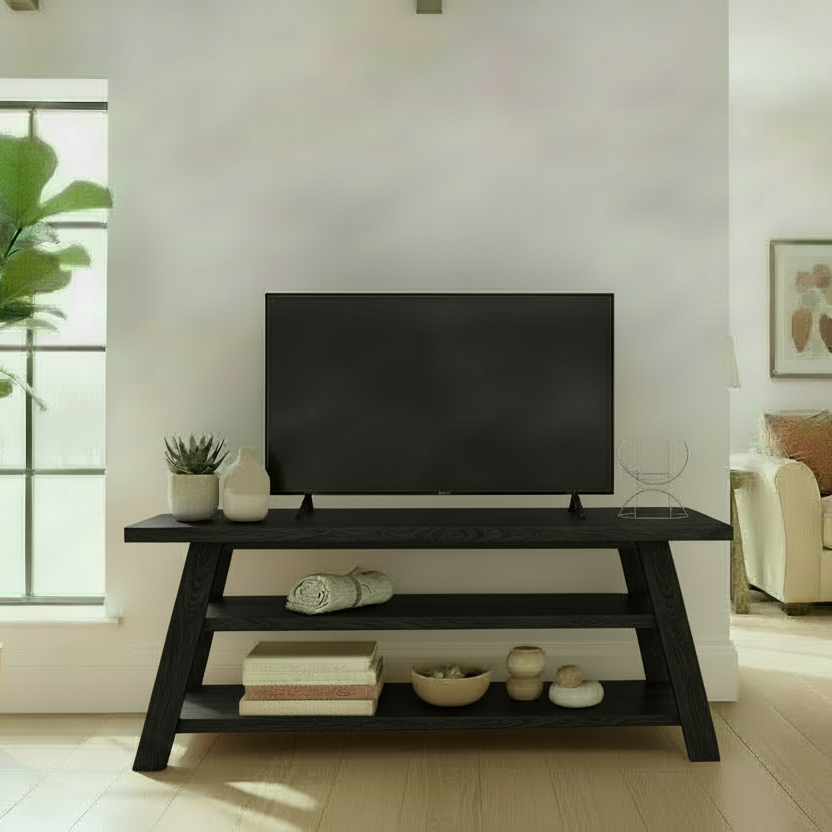 Modern living room with a TV on a stand, sofa, and decor elements.