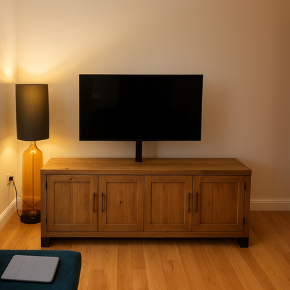 Living room with a wooden TV stand, television, and a lamp.