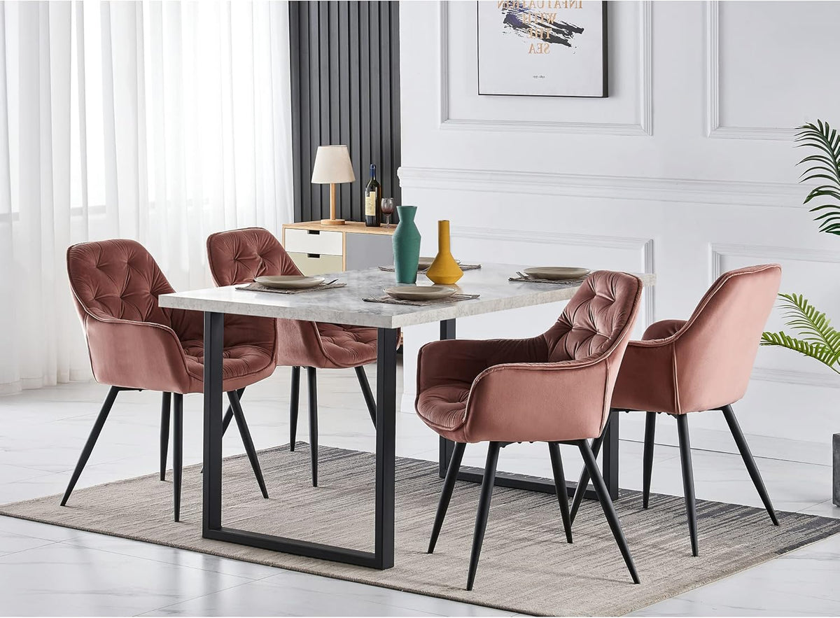 Dining table with four pink chairs in a modern living room.