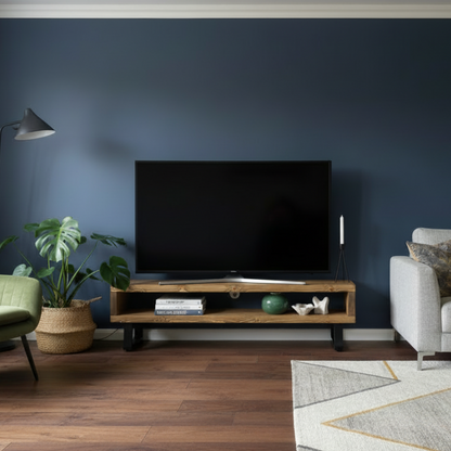 Modern living room with a gray sofa, green armchair, and a television on a wooden stand.