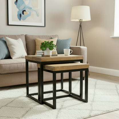 Nest of wooden tables in a living room setting with a couch and lamp.